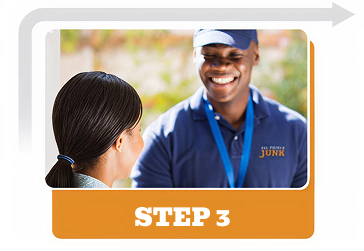 A smiling All Things Junk employee